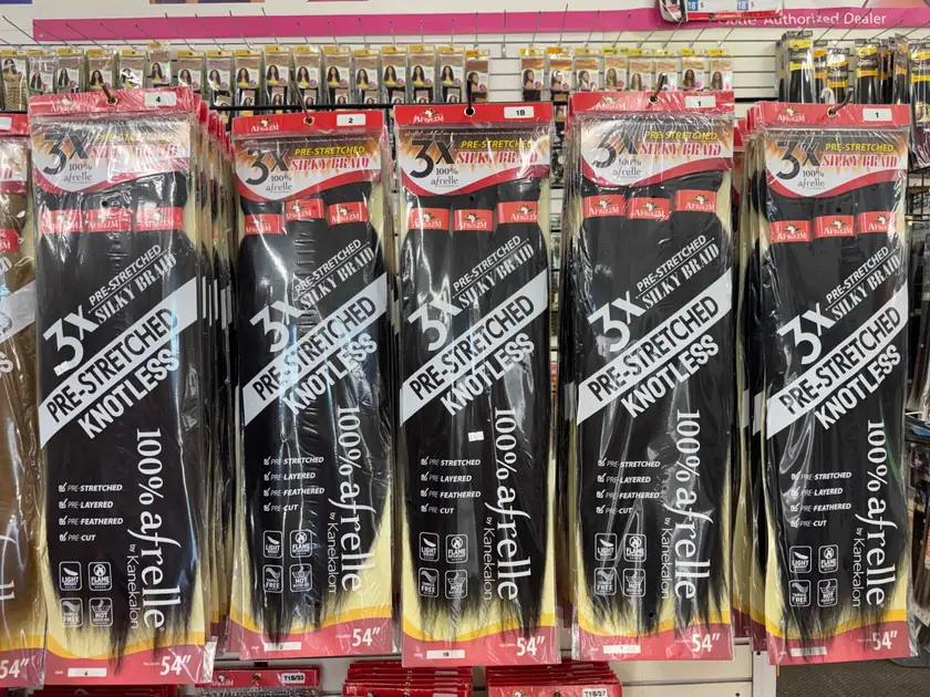 Afreezm 3X pre-stretched knotless silky braid packs, 100% Afrelle by Kanekalon, 54 inches, hanging in colors 1, 1B, 2 and 4